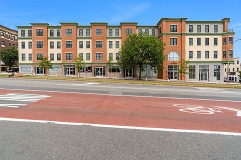 a street view of an apartment building on a city street